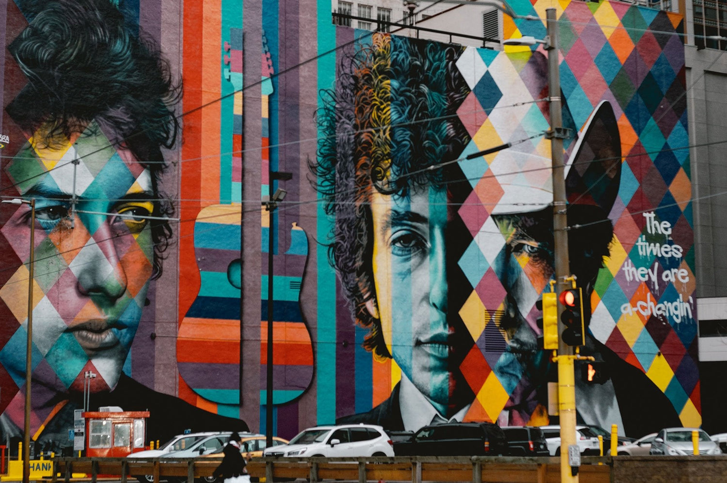 Photo of a colorfull mural of Bob Dylan on a large building.