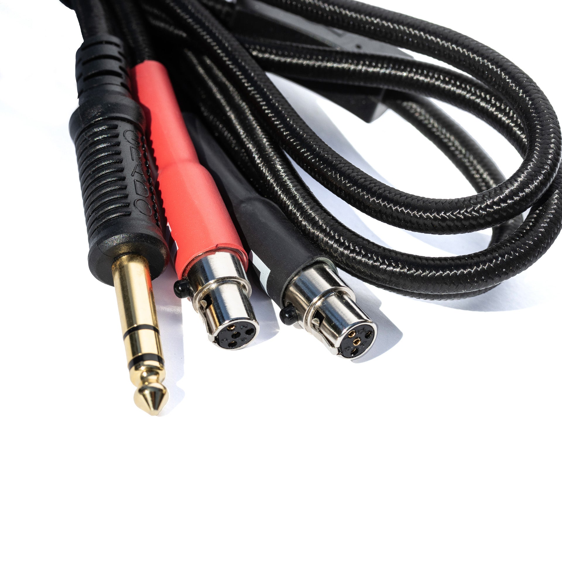 Close up of Grado Gold Detachable audio Cables on a white background. The plugs are red and black.