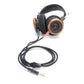 Photo of the Gold Detachable Cables which have red and black plugs and a black wire attached to black Grado Headphones with brown wooden ear cups.