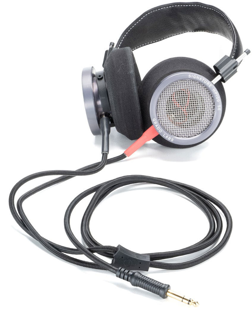 Photo of the Gold Detachable Cables which have red and black plugs and a black wire attached to black Grado Headphones with Silver ear cups.