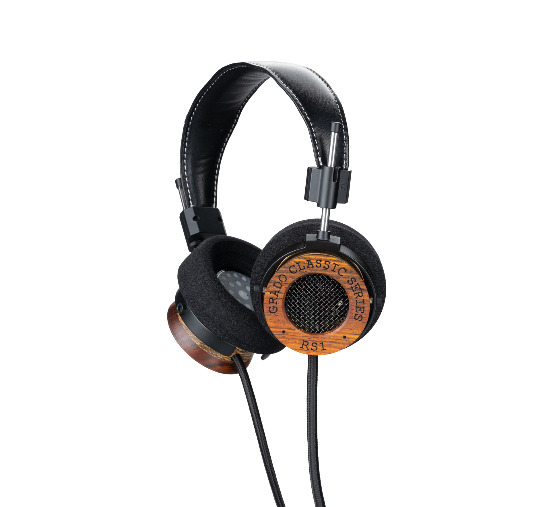 Photo of Grado RS1 Headphones taken from the 3/4 view - One ear cup is facing down while the other ear cup is facing outward - the words - Grado Classic Series - and - RS1 - can be seen on the ear cup.