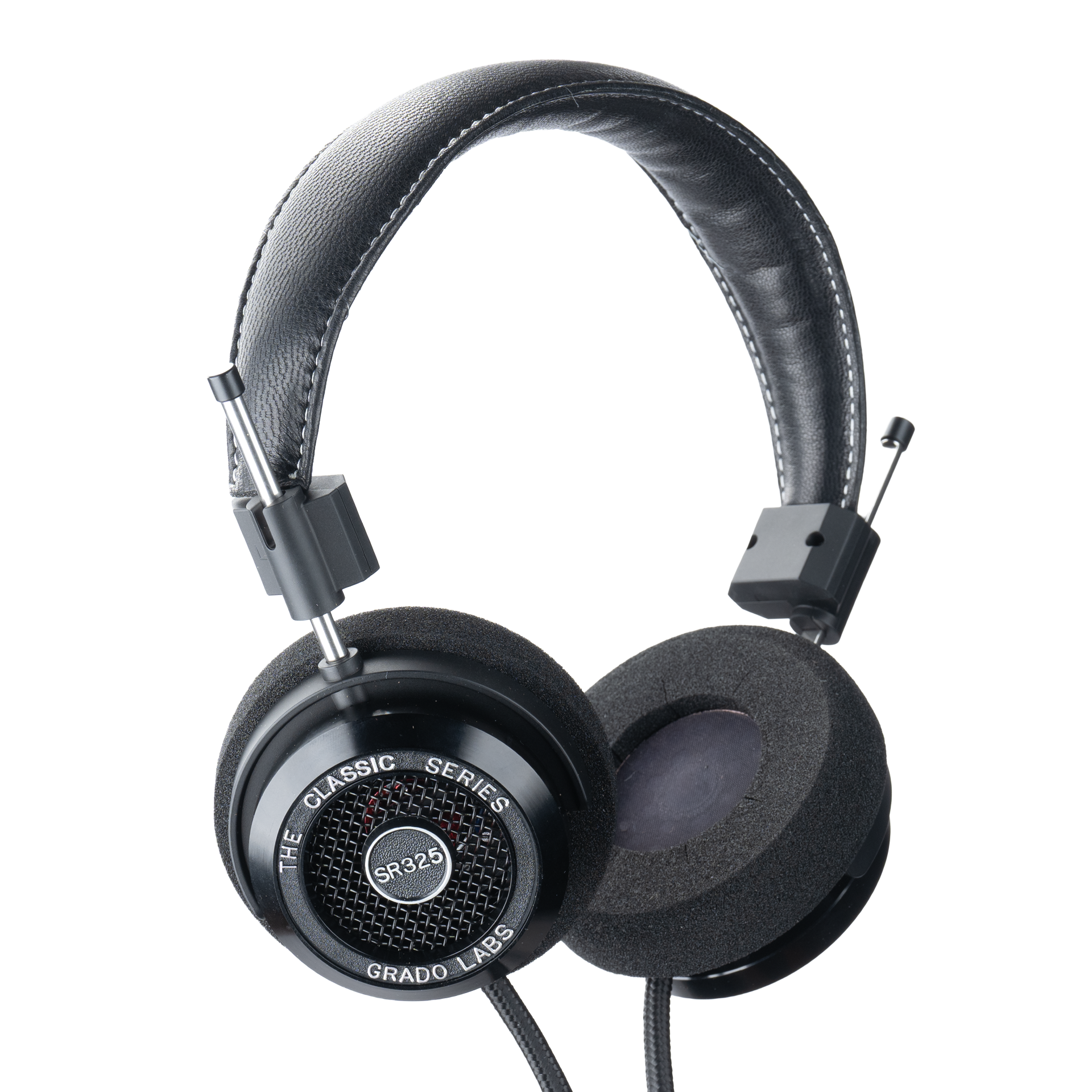 Photo of Grado SR325 Headphones  taken from 3/4 view - one ear cup is facing away from view while the other is showing the model name - SR325 - can be seen in the center and the words - The Classic Series - and - Grado Labs are written on the outside edge of the ear cups. The cables can be seen coming out of the headphone.
