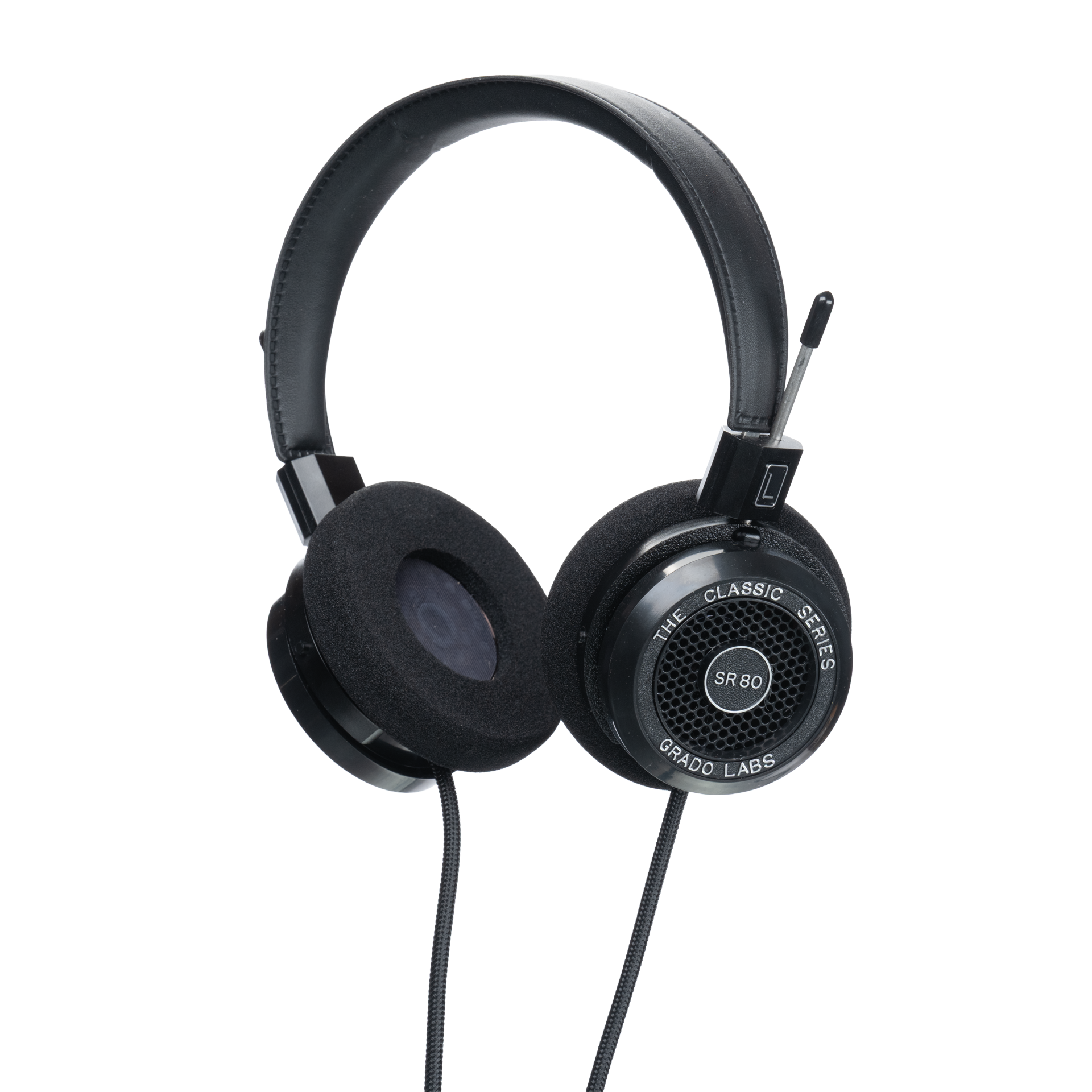 Photo of Grado SR80 Headphones  taken from 3/4 view - one ear cup is facing away from view while the other is showing the model name - SR80 - can be seen in the center and the words - The Classic Series - and - Grado Labs are written on the outside edge of the ear cups. The cables can be seen coming out of the headphone.