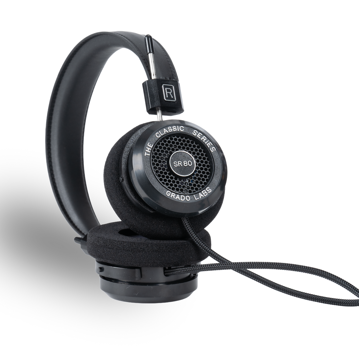 Photo of Grado SR80 Headphones taken from the 3/4 view - One ear cup is facing down while the other ear cup is facing outward - showing the model name in the center - SR80 - and the words - The Classic Series - and - Grado Labs - written along the edge of the ear cups.