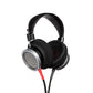 Photo of Grado HP100SE Headphones  taken from 3/4 view - one ear cup is facing away from view while the other is showing the model name - Signature HP100 SE - and - Grado Labs are written on the outside edge of the ear cups. 