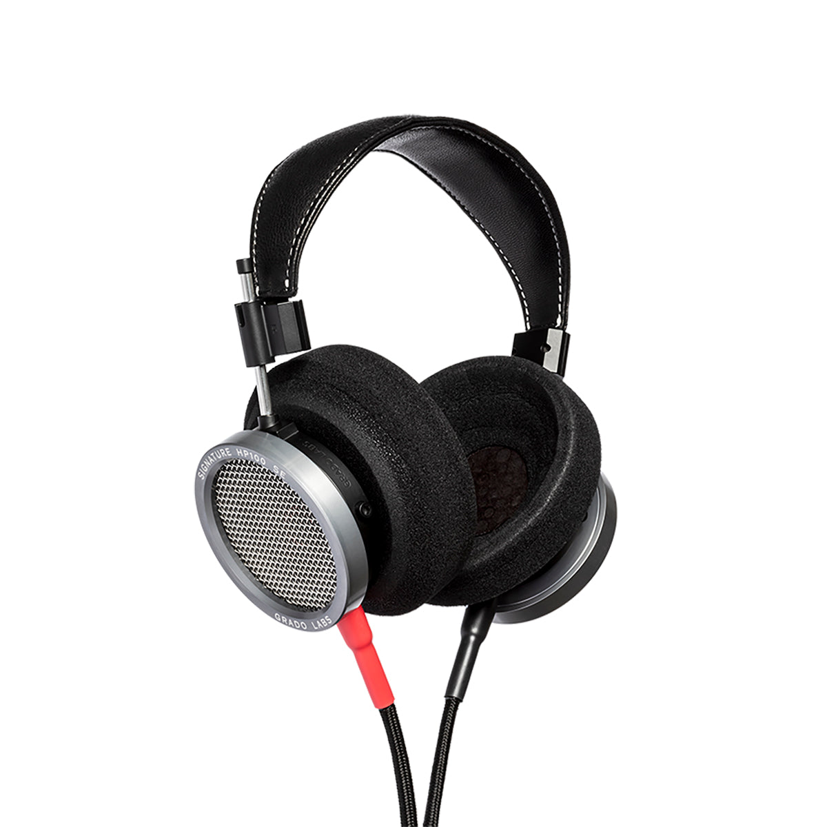 Photo of Grado HP100SE Headphones  taken from 3/4 view - one ear cup is facing away from view while the other is showing the model name - Signature HP100 SE - and - Grado Labs are written on the outside edge of the ear cups. 
