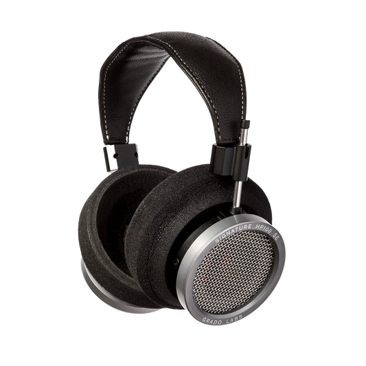 Photo of Grado HP100SE Headphones  taken from 3/4 view - one ear cup is facing away from view while the other is showing the model name - Signature HP100 SE - and - Grado Labs are written on the outside edge of the ear cups. 
