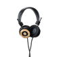 Photo of Grado Hemp Headphones  taken from 3/4 view - one ear cup is facing away from view while the other is showing the Grado logo in the center. The cables can be seen coming out of the headphone.