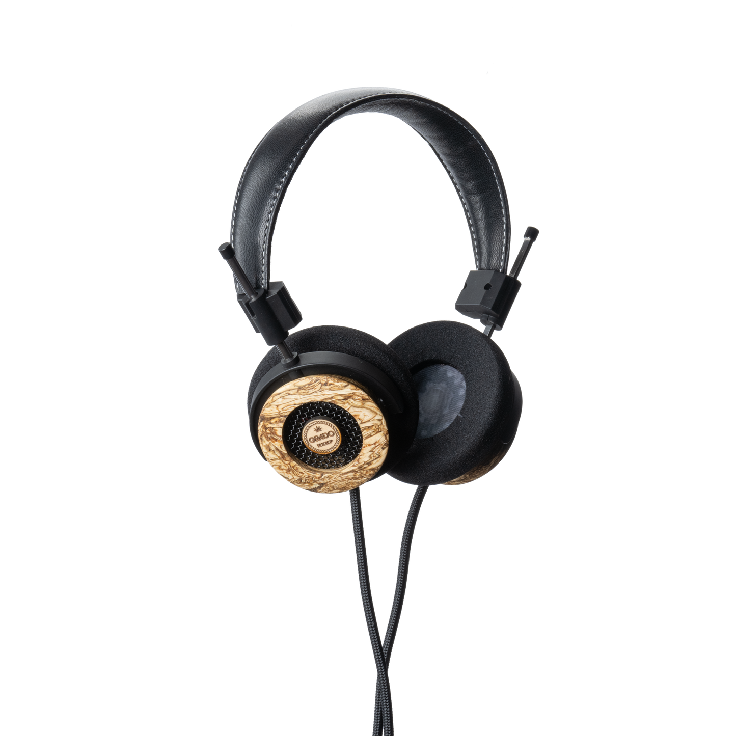 Photo of Grado Hemp Headphones  taken from 3/4 view - one ear cup is facing away from view while the other is showing the Grado logo in the center. The cables can be seen coming out of the headphone.
