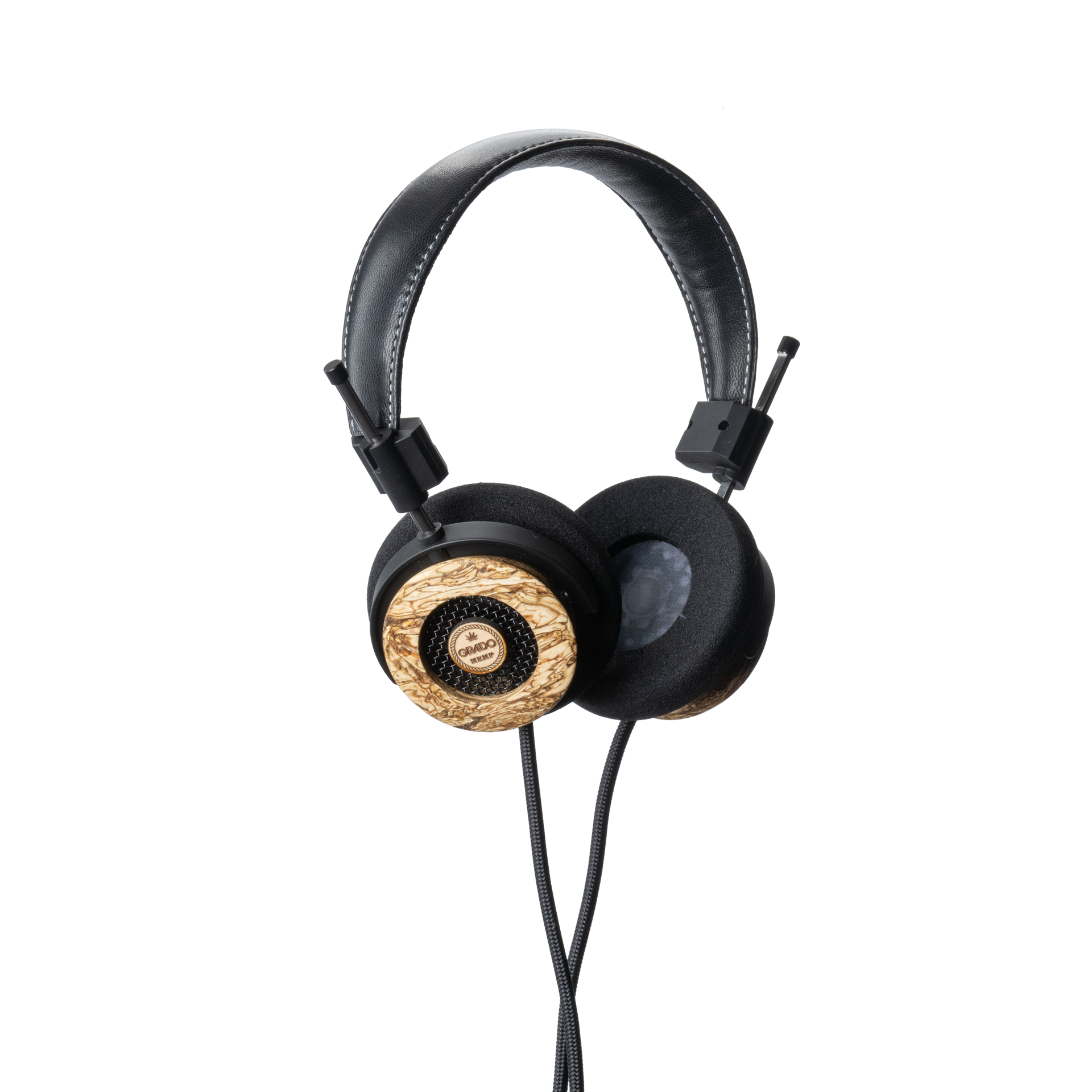 Photo of Grado Hemp Headphones  taken from 3/4 view - one ear cup is facing away from view while the other is showing the Grado logo in the center. The cables can be seen coming out of the headphone.