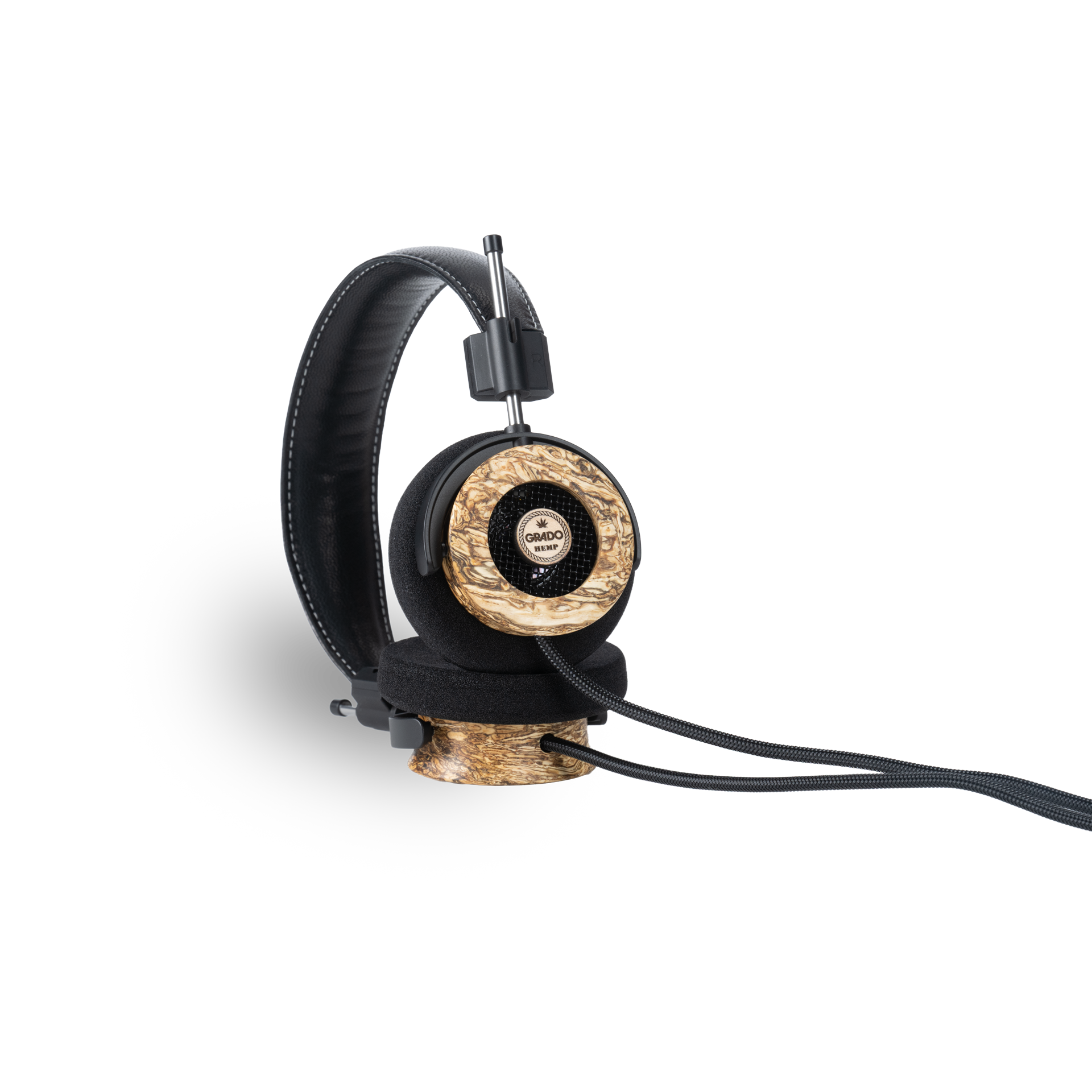 Photo of Grado Hemp Headphones taken from the 3/4 view - One ear cup is facing down while the other ear cup is facing outward - showing the Grado logo.