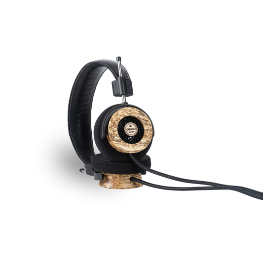 Photo of Grado Hemp Headphones taken from the 3/4 view - One ear cup is facing down while the other ear cup is facing outward - showing the Grado logo.