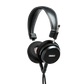 Photo of Grado S150 Headphones taken from the 3/4 view - the Grado logo is featured in the center of the ear cup and the black cables can be seen coming out of the headphone.