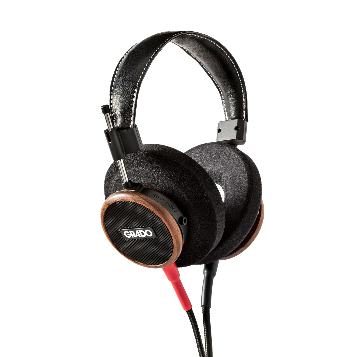 Photo of Grado S550 Headphones taken from the 3/4 view - the Grado logo is featured in the center of the ear cup and the red/black cables can be seen coming out of the headphone.