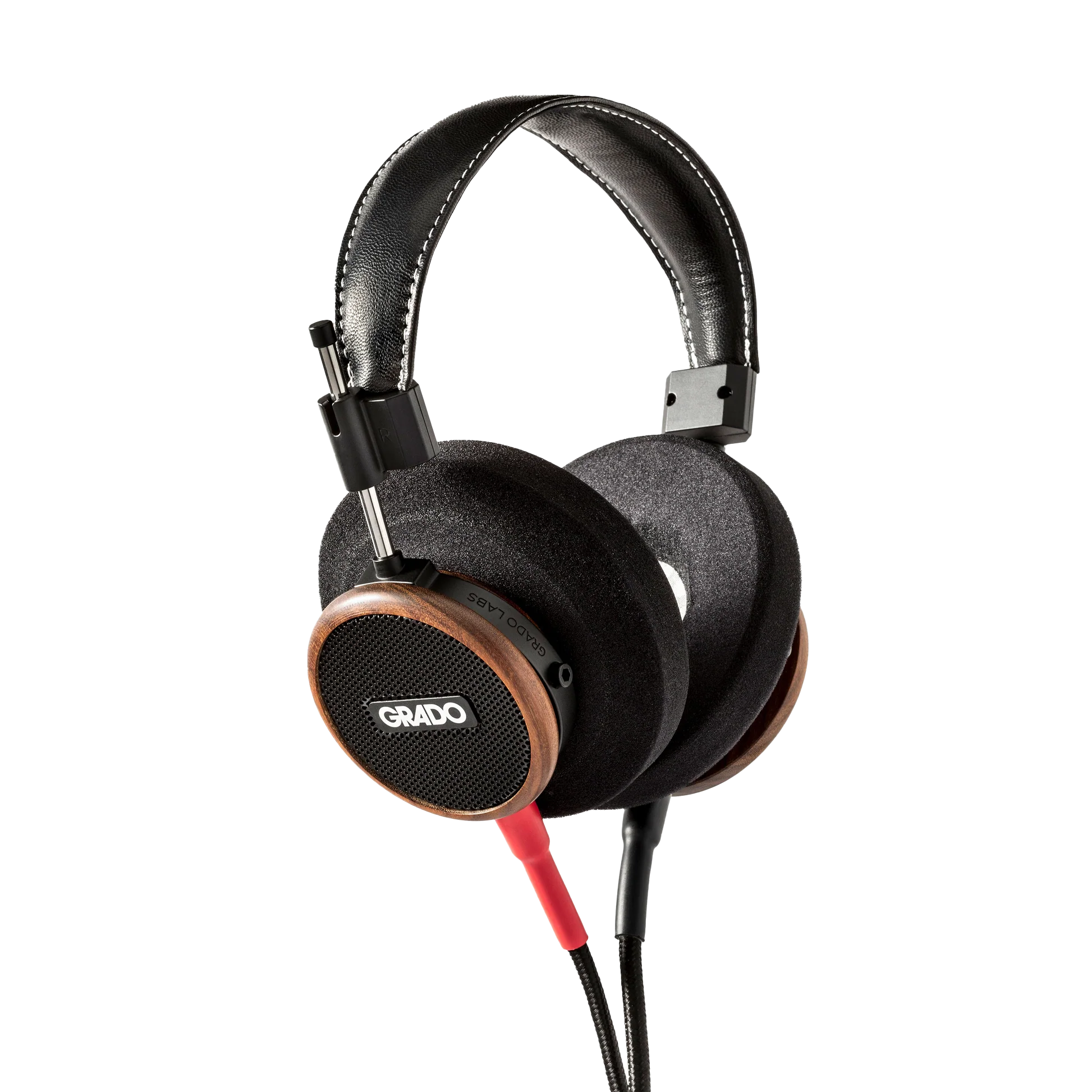Photo of Grado S550 Headphones taken from the 3/4 view - the Grado logo is featured in the center of the ear cup and the red/black cables can be seen coming out of the headphone.