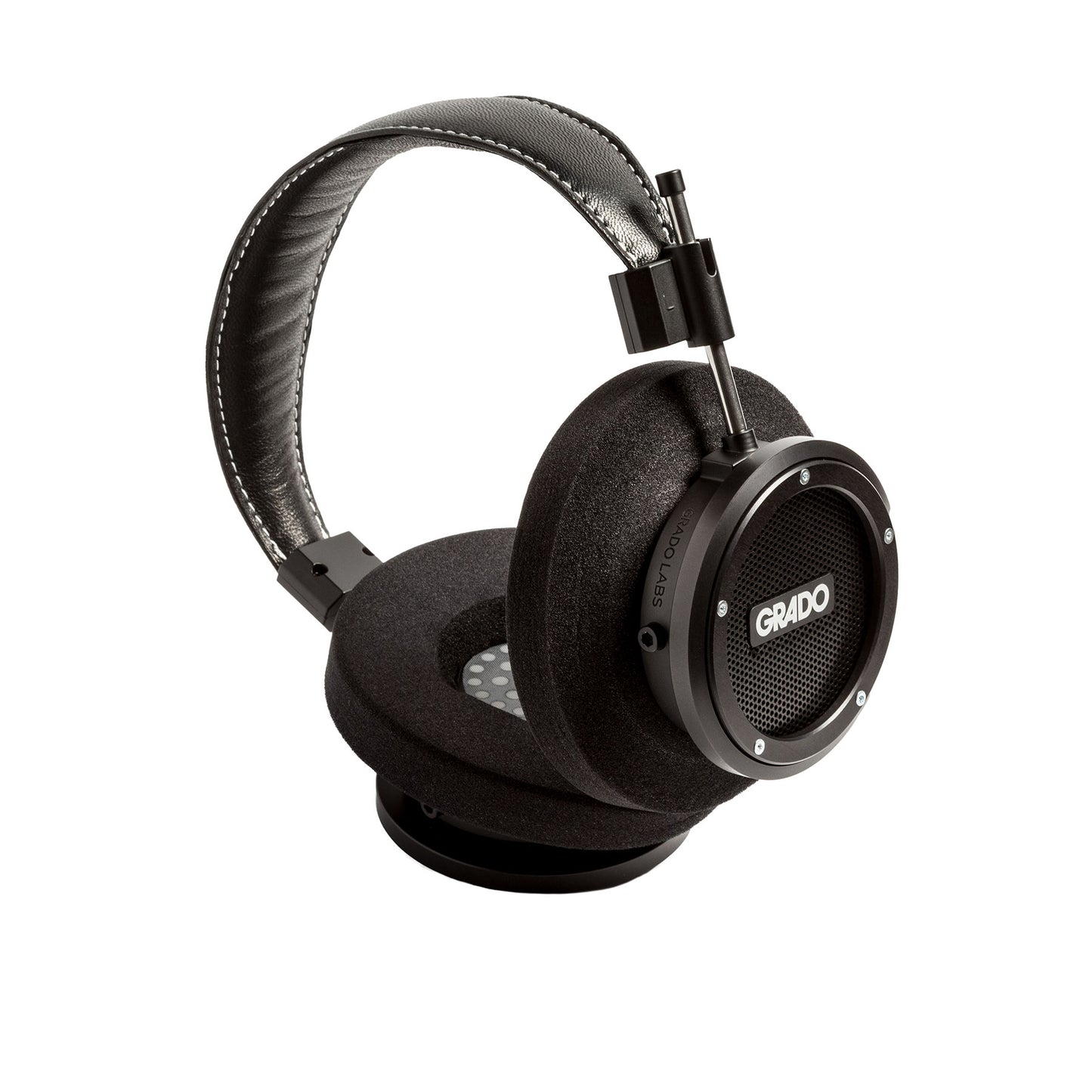 Photo of Grado S750 Headphones on a white background taken from the 3/4 view - One ear cup is facing down while the other ear cup is facing outward - showing the Grado logo.