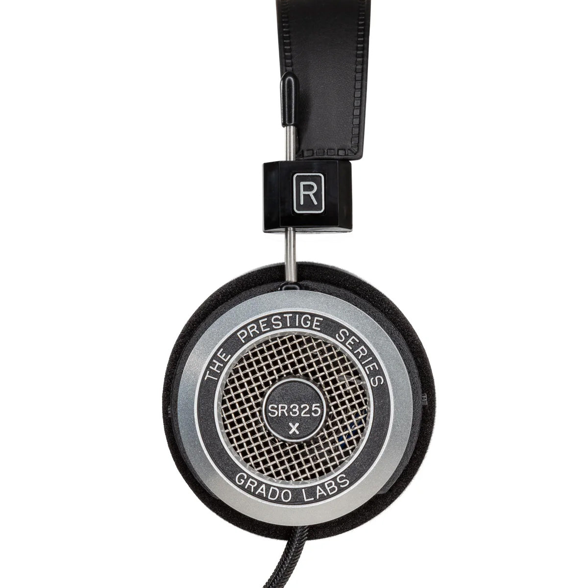 Photo of the Grado SR325x Headphones taken from the side - the model name - SR325x - is featured in the center of the ear cup. The Words - The Prestige Series - and - Grado Labs are written around the outer edge of the ear cup.