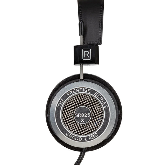 Photo of the Grado SR325x Headphones taken from the side - the model name - SR325x - is featured in the center of the ear cup. The Words - The Prestige Series - and - Grado Labs are written around the outer edge of the ear cup.