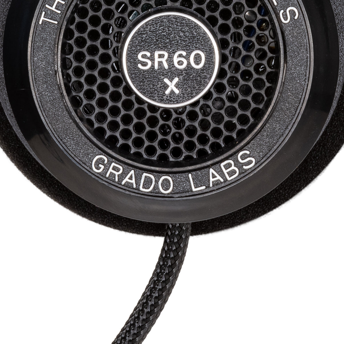 Close up photo of the Grado SR60x Headphones taken from the side - the model name - SR60x - is featured in the center of the ear cup. The Words - The Prestige Series - and - Grado Labs are written around the outer edge of the ear cup.