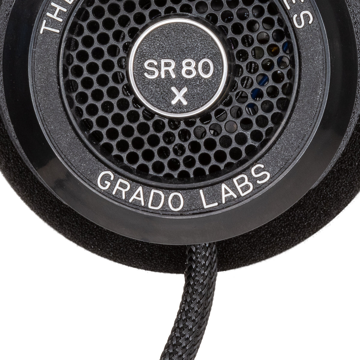 Close up photo of the Grado SR80x Headphones taken from the side - the model name - SR80x - is featured in the center of the ear cup. The Words - The Prestige Series - and - Grado Labs are written around the outer edge of the ear cup.