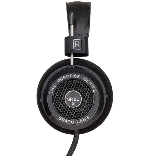 Photo of the Grado SR80x Headphones taken from the side - the model name - SR80x - is featured in the center of the ear cup. The Words - The Prestige Series - and - Grado Labs are written around the outer edge of the ear cup.