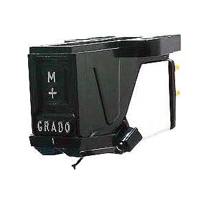 Photo of the Grado mono phono cartridge taken from the 3/4 view. The cartridge is black and silver. It has the letter 'M' and '+' and the word 'GRADO' in silver on the front of it. Photo by Jones Studio Ltd.