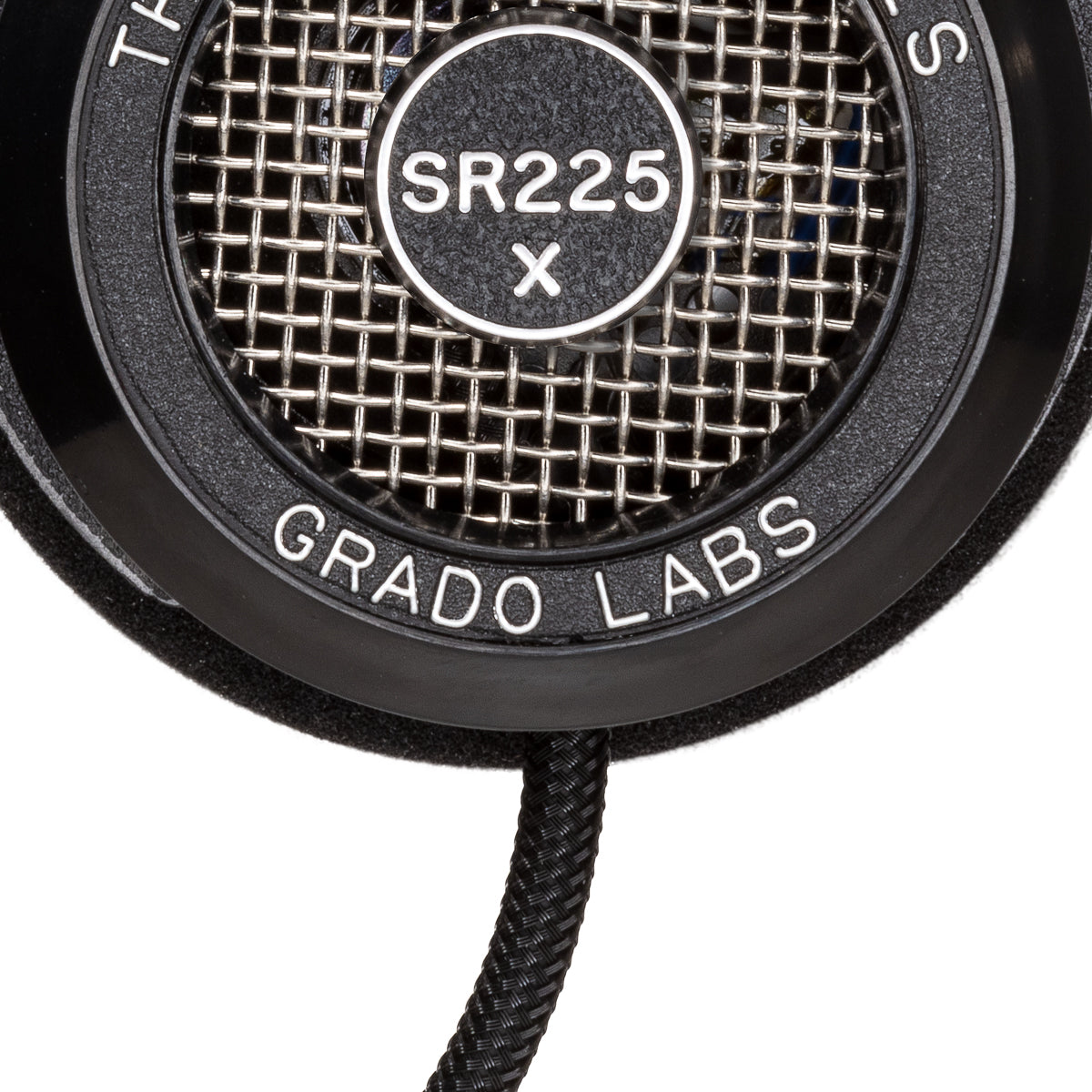 Close up photo of the Grado SR225x Headphones taken from the side - the model name - SR225x - is featured in the center of the ear cup. The Words - The Prestige Series - and - Grado Labs are written around the outer edge of the ear cup.