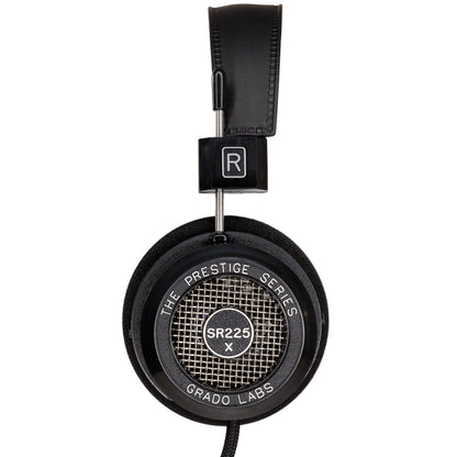 Photo of the Grado SR225x Headphones taken from the side - the model name - SR225x - is featured in the center of the ear cup. The Words - The Prestige Series - and - Grado Labs are written around the outer edge of the ear cup.